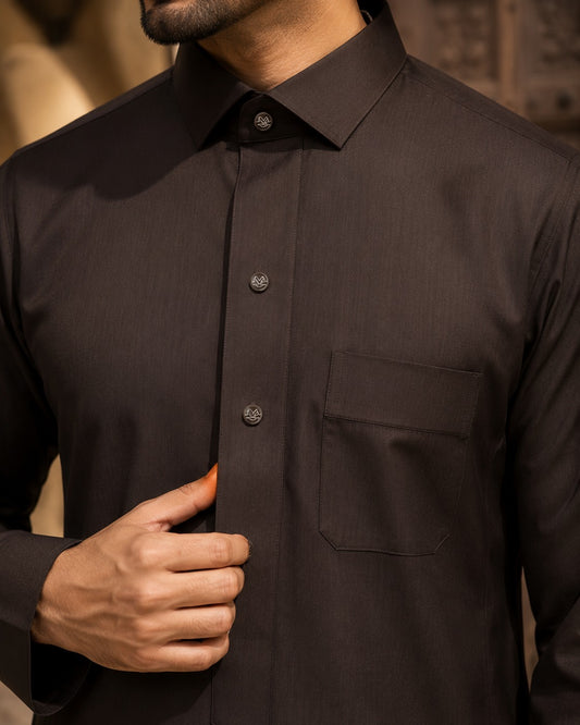 Elite chocolate brown thobe by Al-Emara, featuring traditional Islamic attire with a long, flowing design and intricate embroidery.