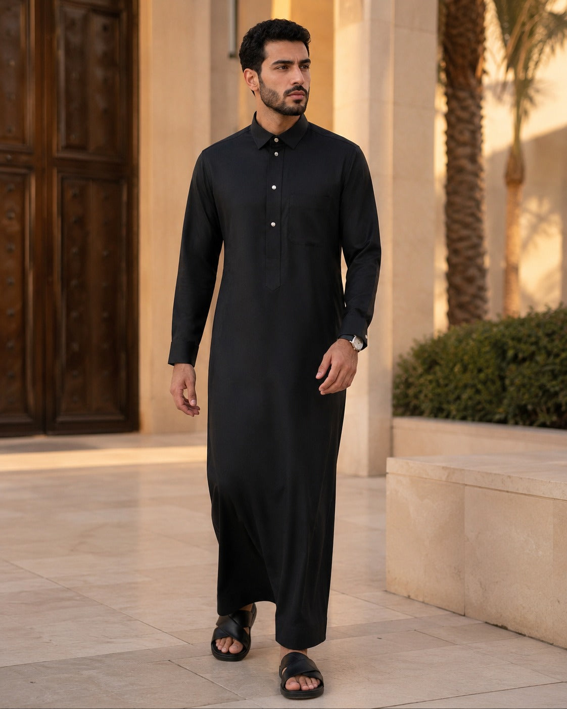 Black traditional Thobe by Al-Emara with a classic fit, featuring intricate embroidery and a sleek, elegant design for formal occasions.