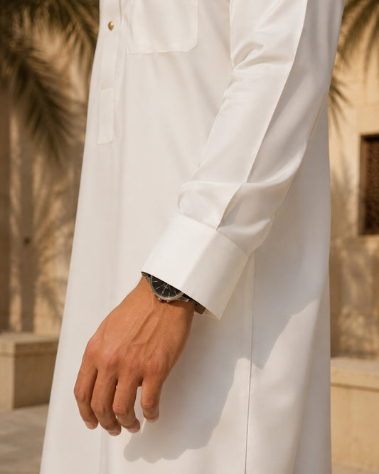 Al-Emara feather-light classic white thobe displayed on a hanger, showcasing its smooth fabric and traditional fit.