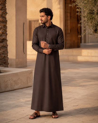 Elite chocolate brown thobe by Al-Emara featuring traditional design and elegant fabric, displayed on a mannequin.