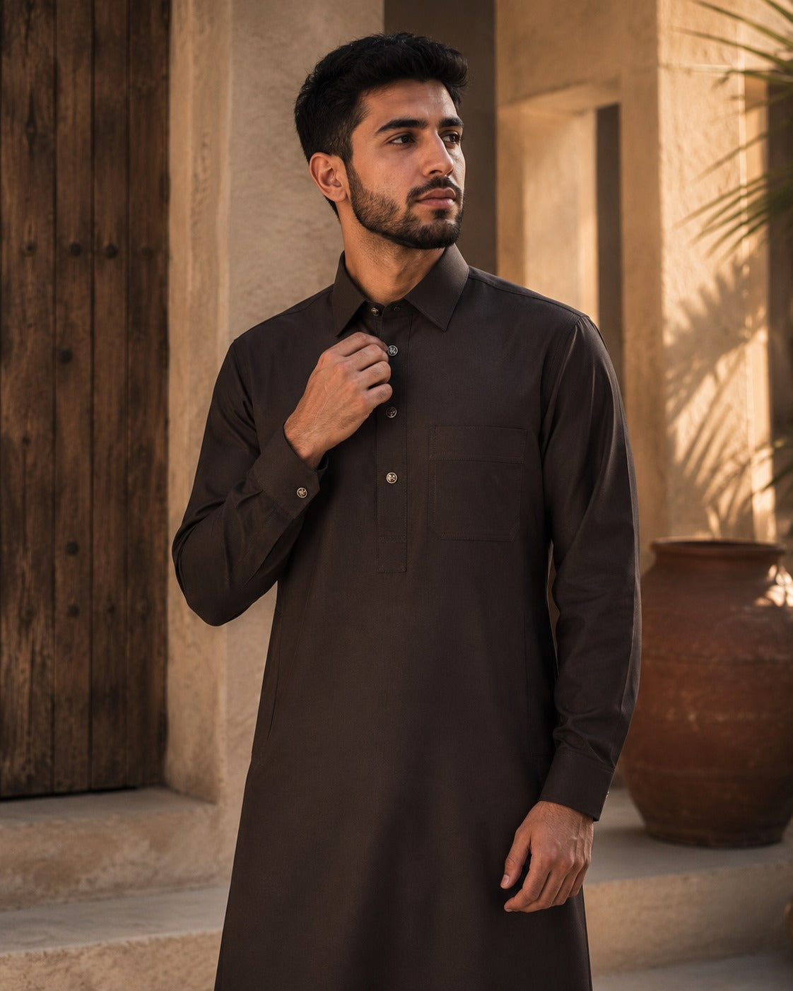 Elite chocolate brown thobe by Al-Emara, featuring a traditional long Islamic garment with detailed embroidery and a comfortable fit.
