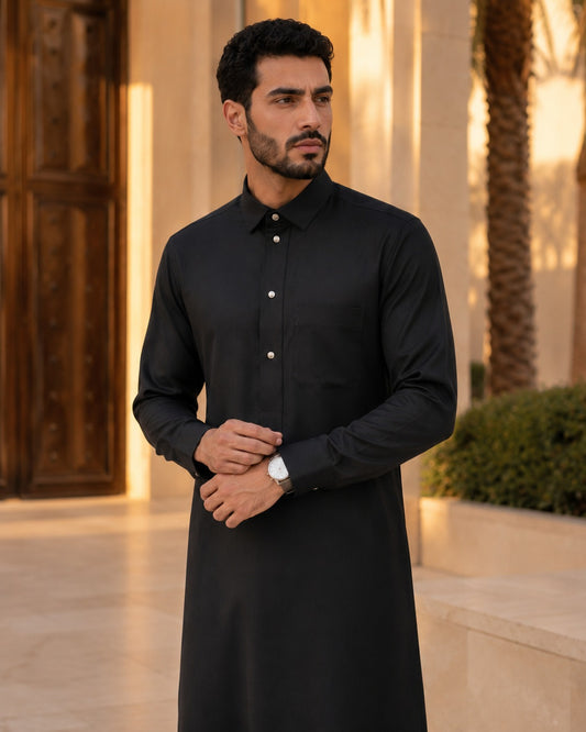 Black premium classic thobe by Al-Emara, shown on a mannequin with detailed embroidery and a traditional fit.