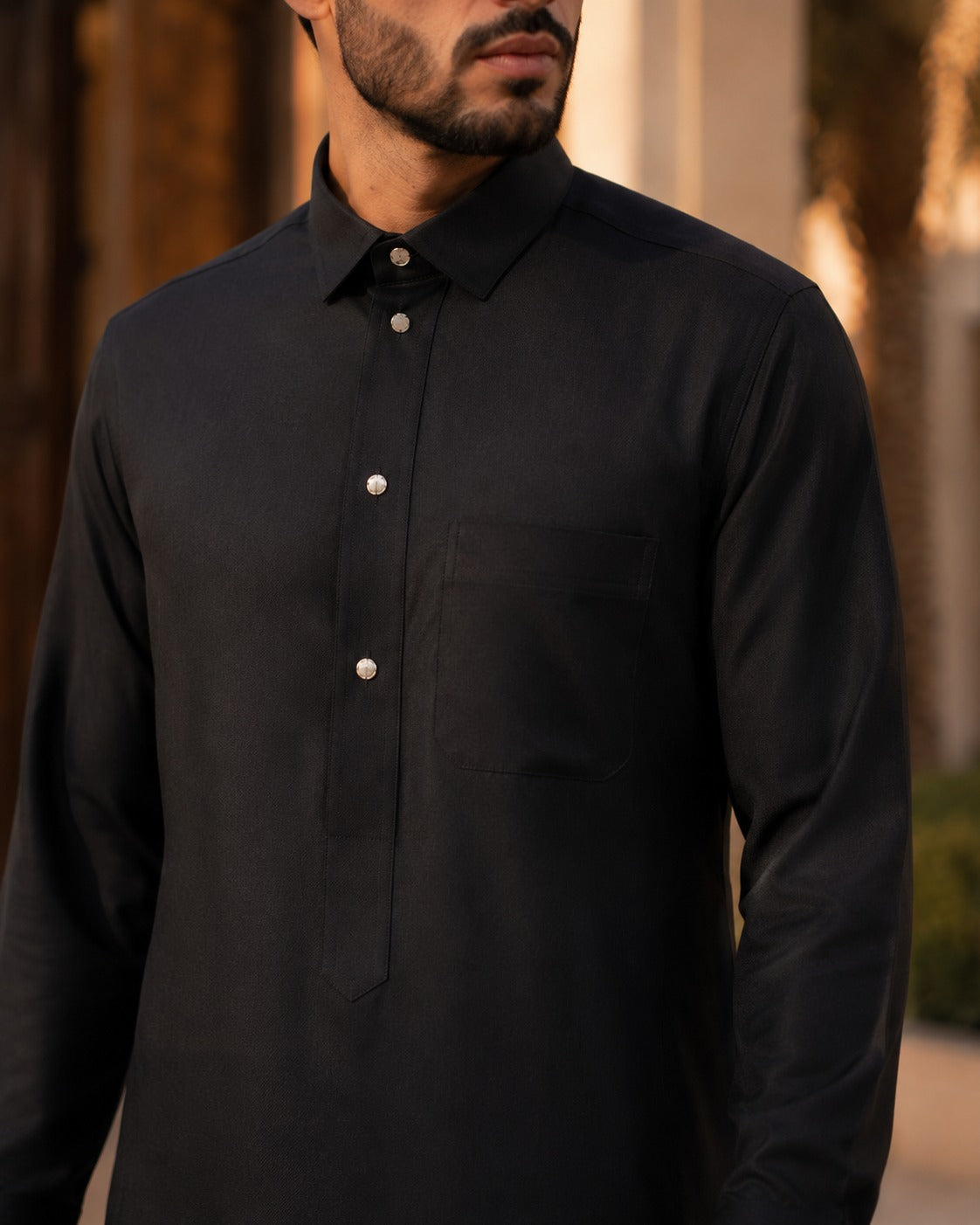 Elegant black thobe by Al-Emara, featuring a classic design with detailed embroidery and a comfortable fit.