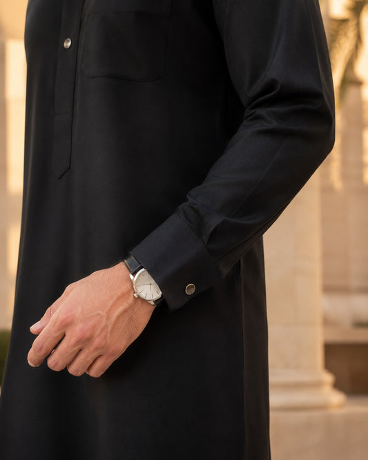 Black classic thobe by Al-Emara, featuring a long, flowing traditional garment with a high collar and elegant design.
