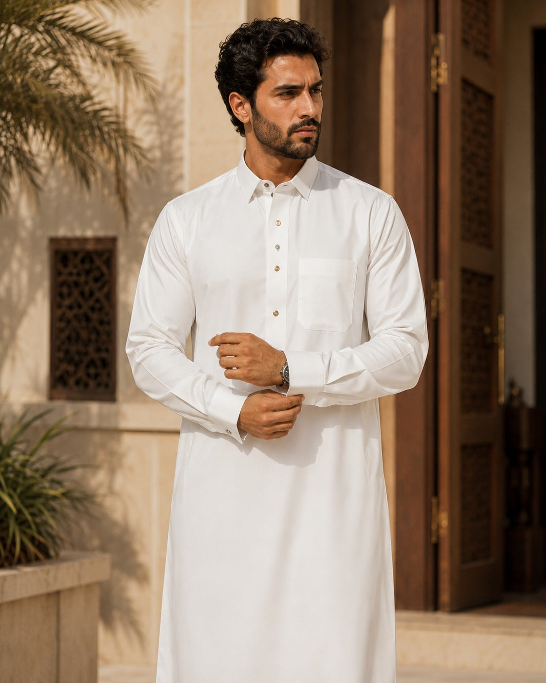 Al-Emara feather-light classic white thobe displayed on a hanger, showcasing its smooth fabric and traditional design.